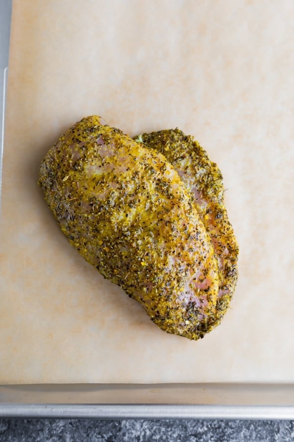 lemon pepper chicken before baking on a baking sheet