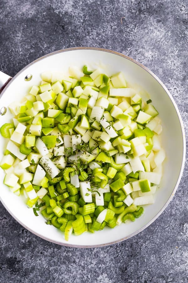 satueeing the thanksgiving stuffing recipe ingredients in a pan