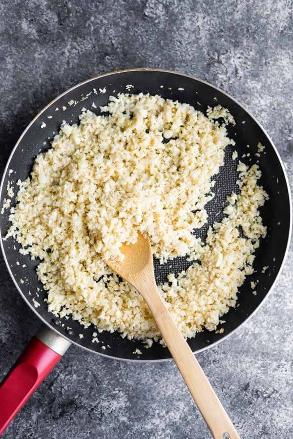 cooking cauliflower rice in a pan from overhead