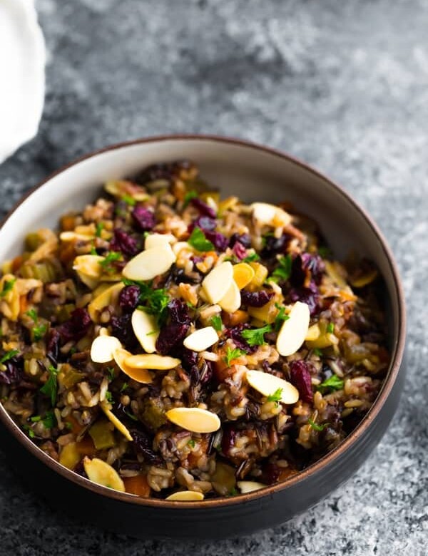 bowl of cranberry almond rice pilaf on gray background