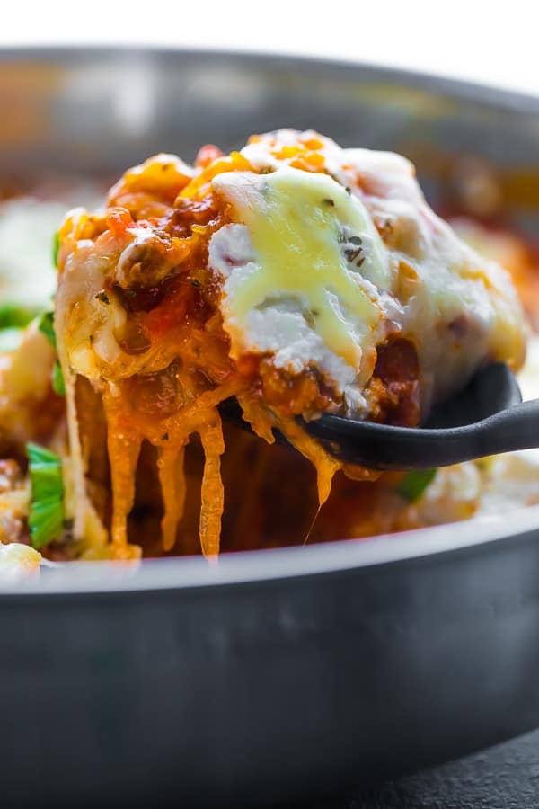 scooping the spaghetti squash lasagna out of the pan