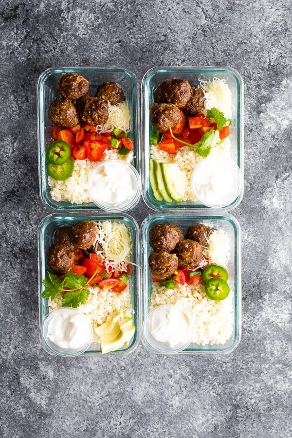 overhead shot of four glass meal prep containers with low carb meatball burrito bowls