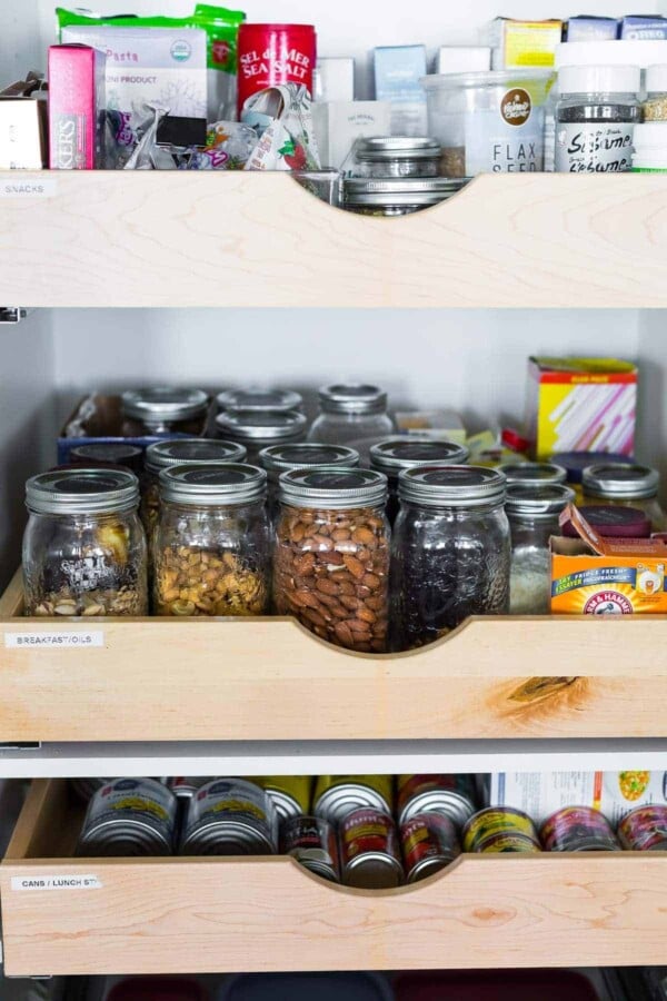 sliding shelf filled with glass mason jars filled with ingredients