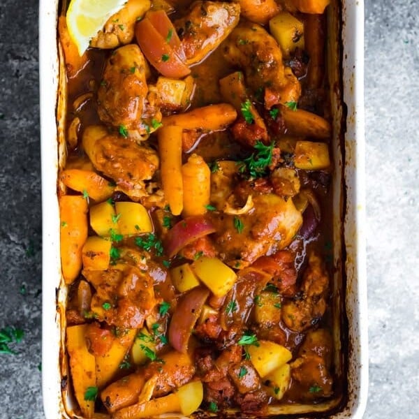 overhead shot of Portuguese chicken bake with fresh lemon slice in baking dish