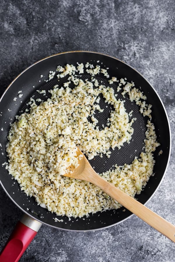 cooking the sesame ginger cauliflower rice in a pan