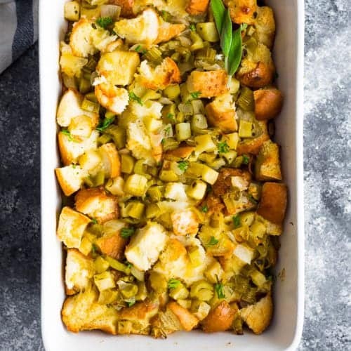 overhead shot of sage apple stuffing in white serving dish