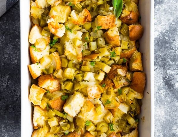 overhead shot of sage apple stuffing in white serving dish