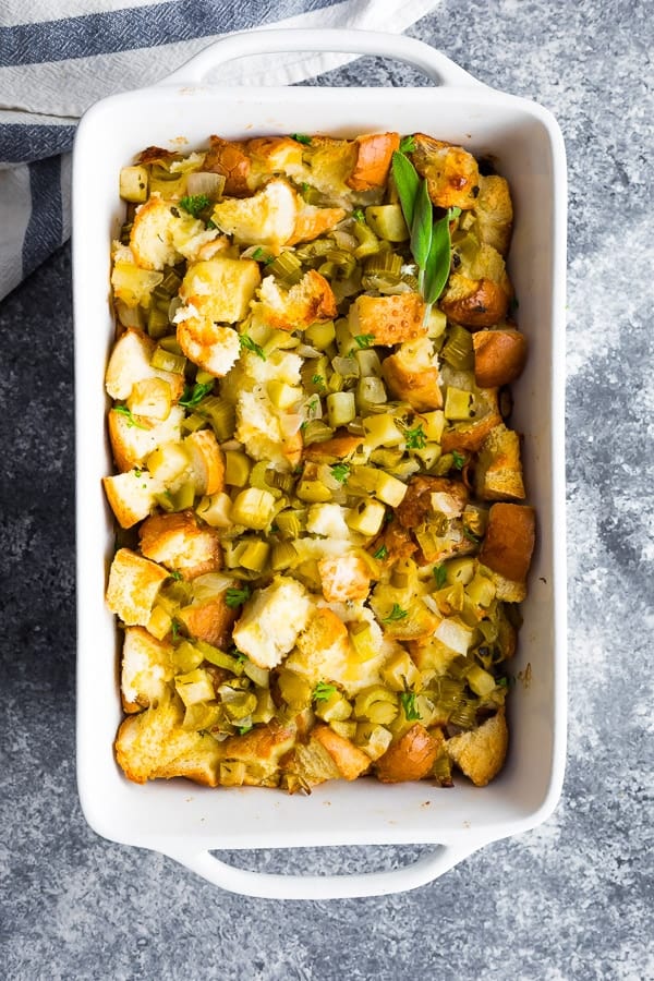 overhead shot of sage apple stuffing in white serving dish