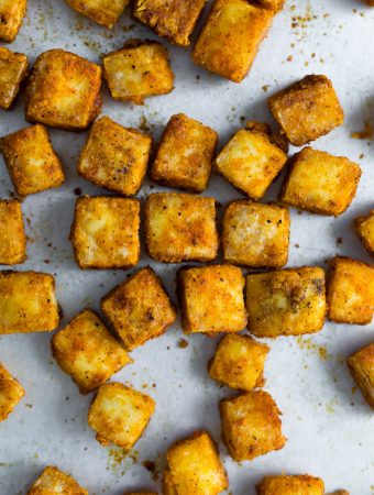 overhead shot of baked tofu cubes on baking pan