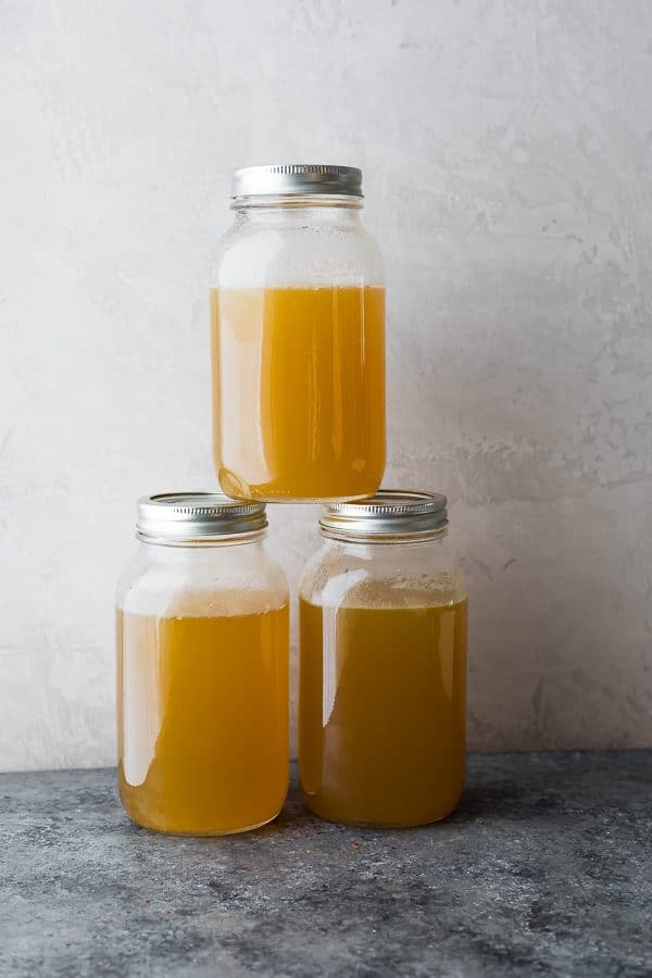 three glass stacked mason jars filled with turkey bone broth