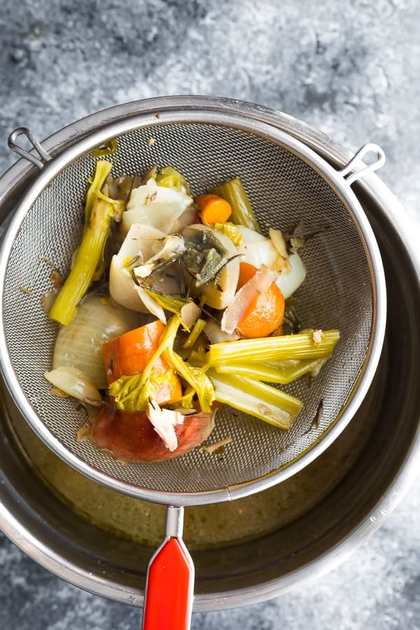 making turkey stock by pouring over a colander