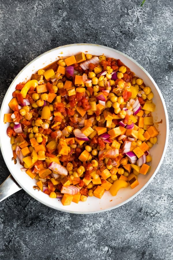 uncooked Vegan Moroccan Chickpea Skillet ingredients in white pan