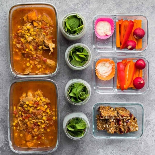 overhead view of nine meal prep containers showing how to portion food out