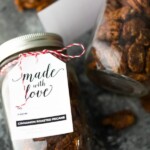 Close up shot of mason jar filled with cinnamon roasted pecans and tag saying made with love