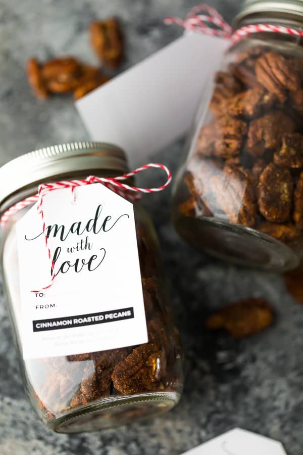 Close up shot of mason jar filled with cinnamon roasted pecans and tag saying made with love