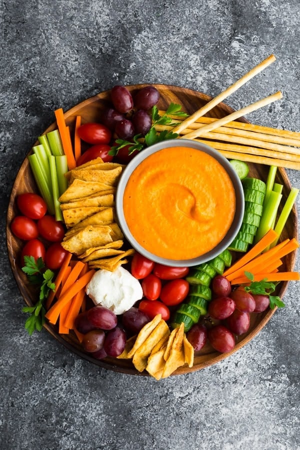 overhead view of the roasted red pepper hummus on appetizer tray