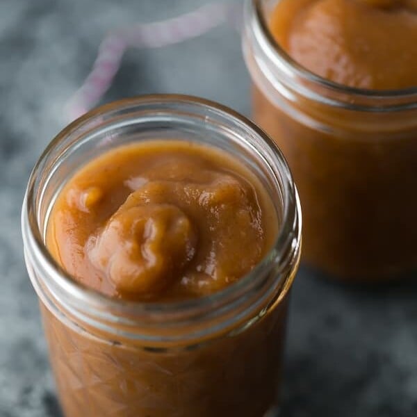 two mason jars filled with apple butter