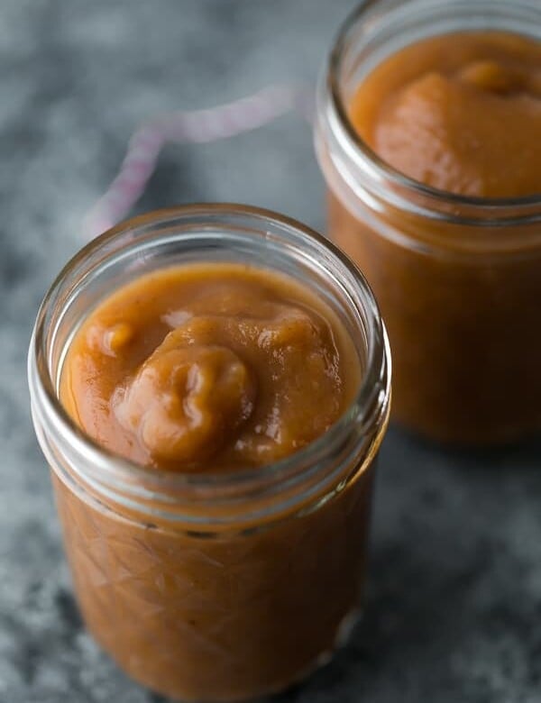 two mason jars filled with apple butter