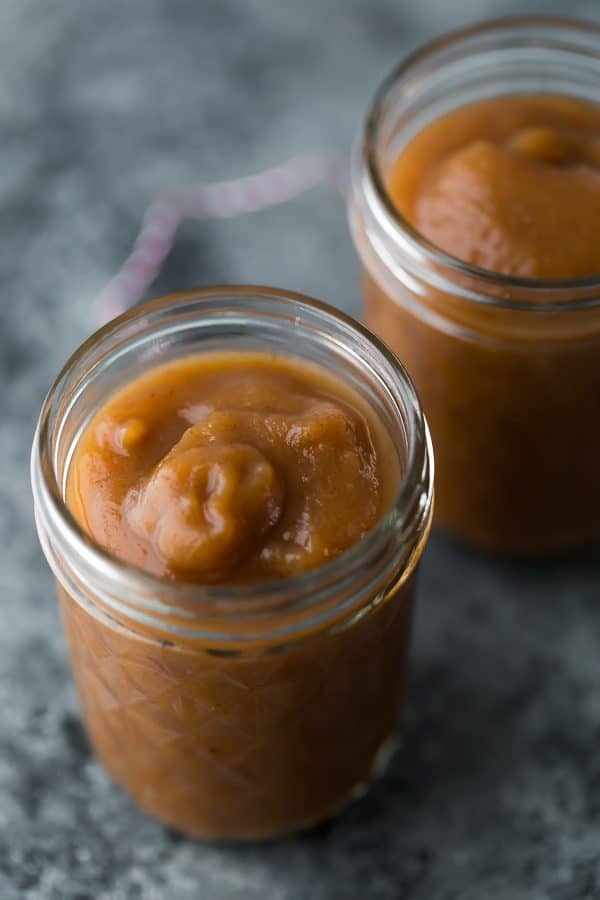 two mason jars filled with apple butter