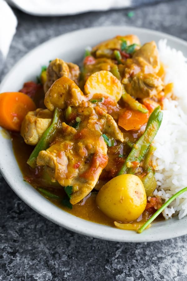 close up of chicken curry in bowl with rice