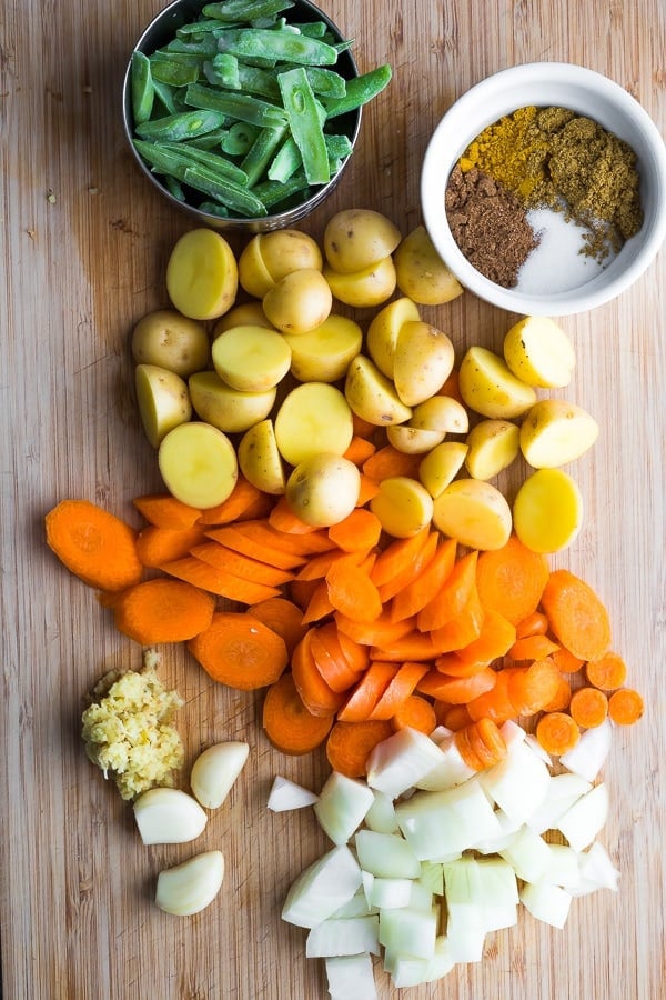 Ingredients for curry chicken on cutting board