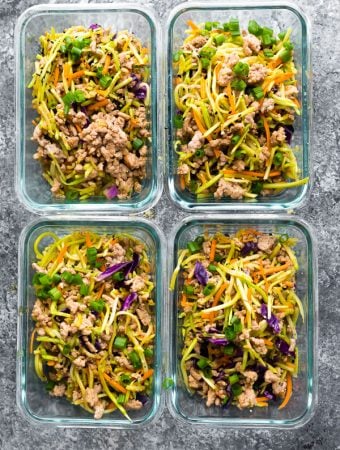 four glass meal prep containers filled with egg roll in a bowl