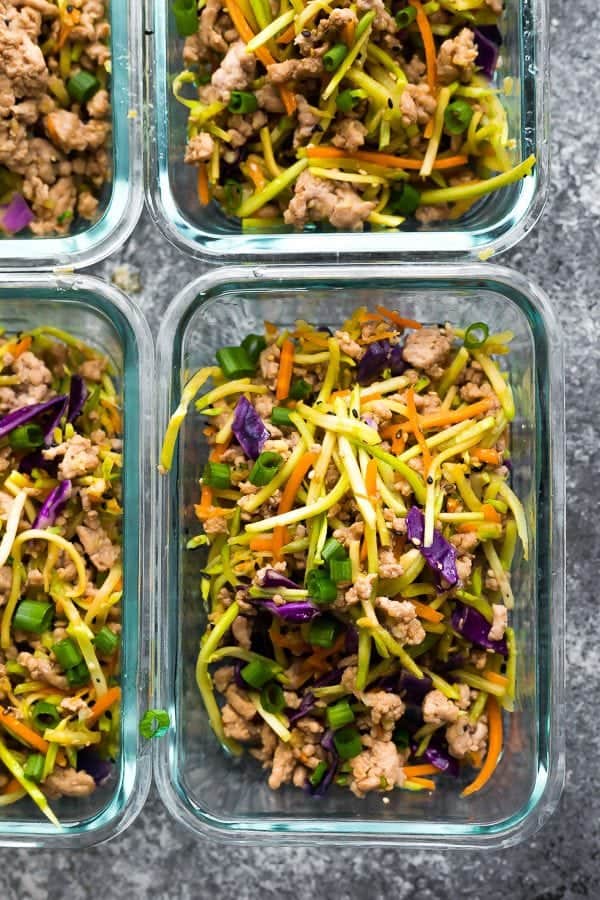 overhead shot of four glass meal prep containers filled with egg roll in a bowl