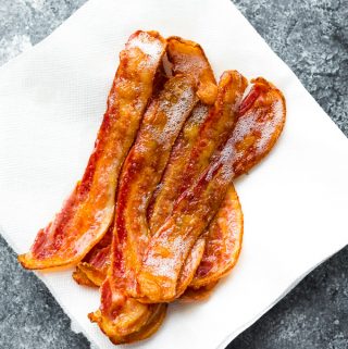 slices of bacon sitting on white paper towel