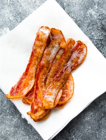 slices of bacon sitting on white paper towel