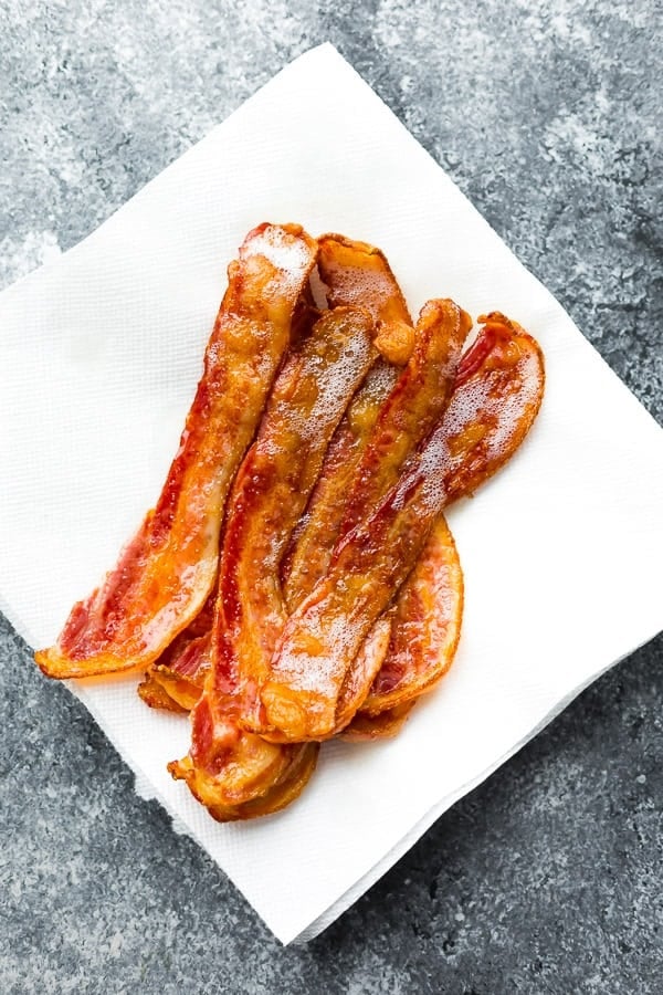 slices of bacon sitting on white paper towel