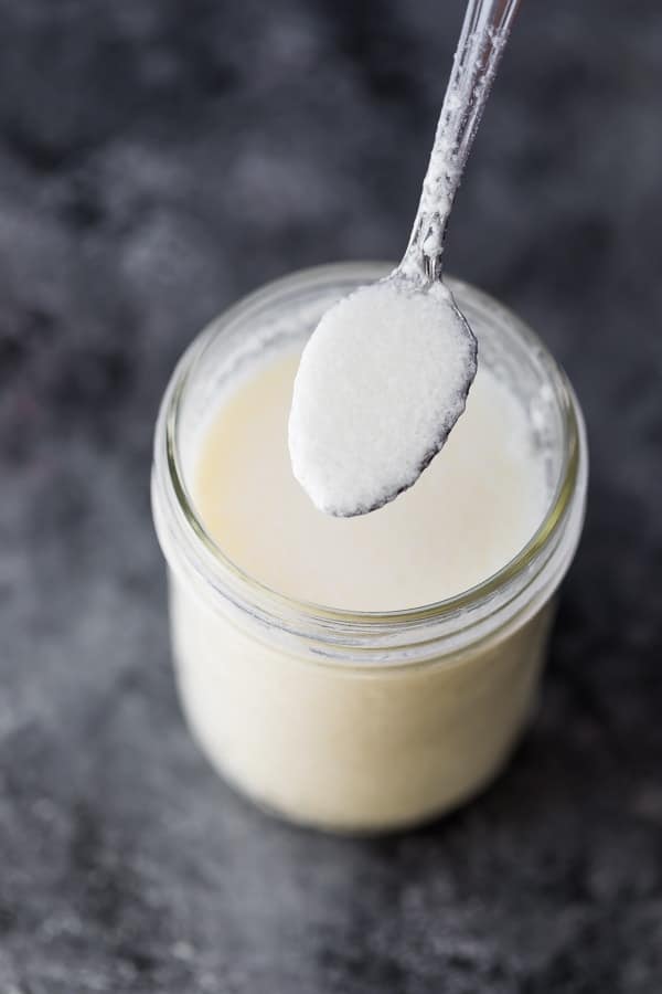 how to make buttermilk from milk- spoon showing curdled milk