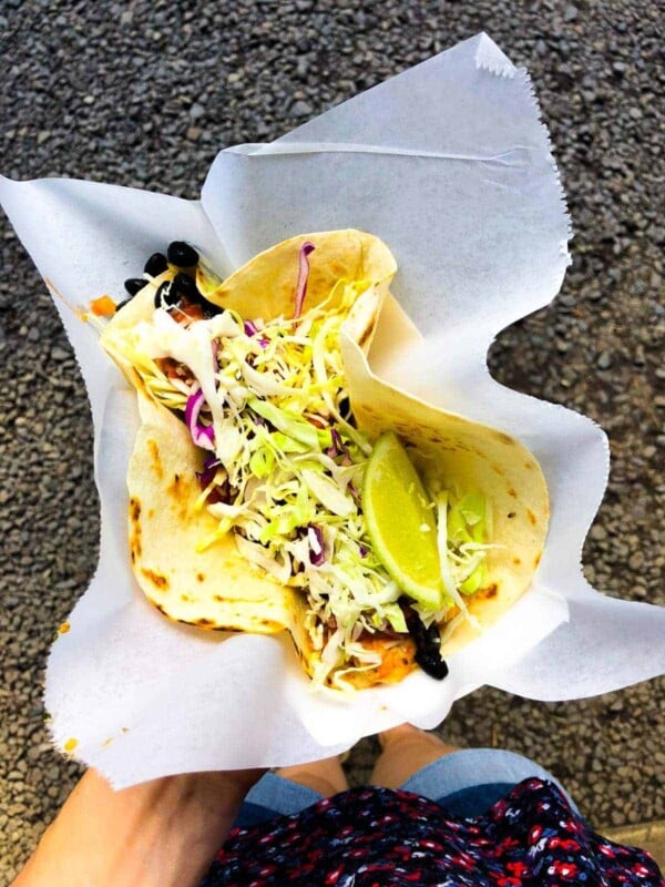 overhead shot of a hand holding up a large taco 