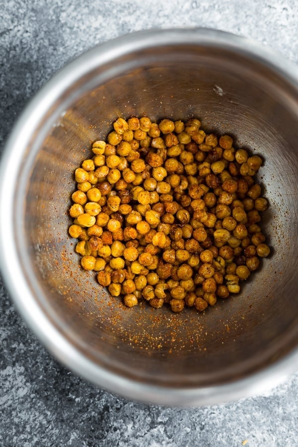showing how to roast chickpeas- tossing in spices after roasting