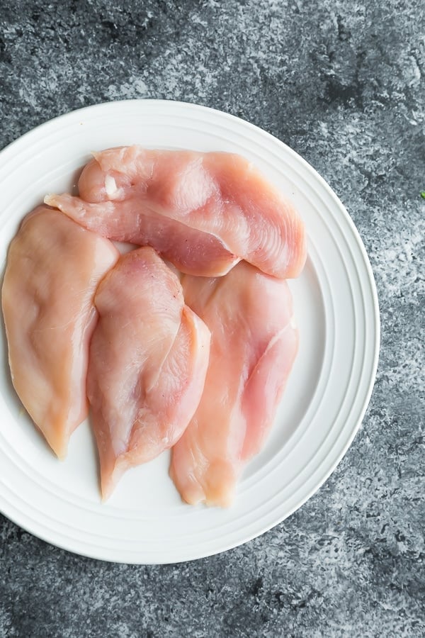 chicken sliced in half for the healthy chicken parmesan 