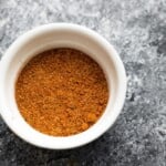 overhead shot of taco seasoning in white bowl on gray background