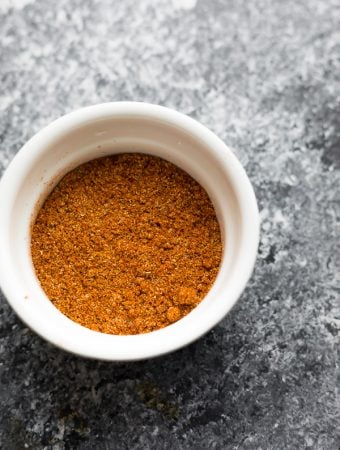 overhead shot of taco seasoning in white bowl on gray background