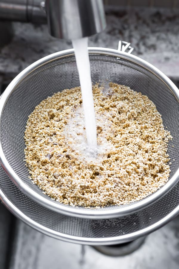 quinoa cooking instructions- step one: rinsing quinoa in a colander