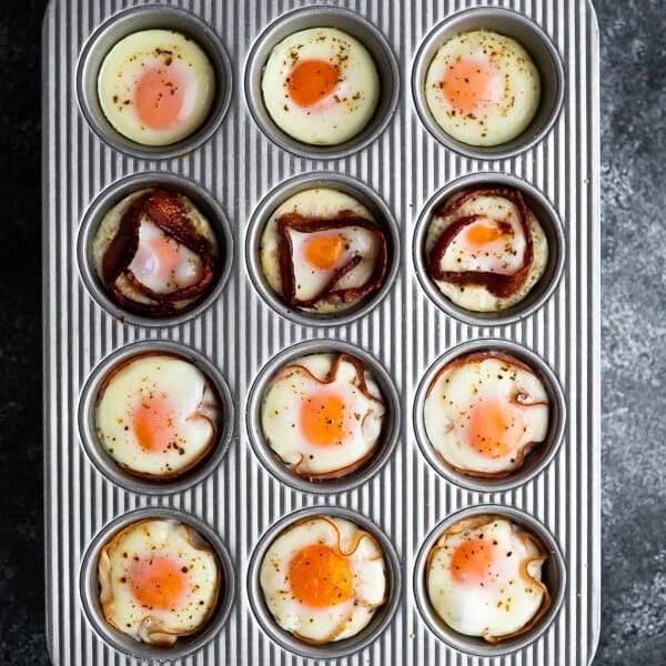 overhead shot of a variety of baked eggs in muffin tin