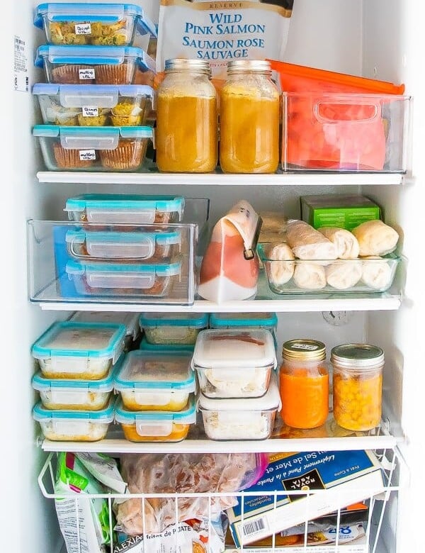 An open freezer filled with food prep containers and meals