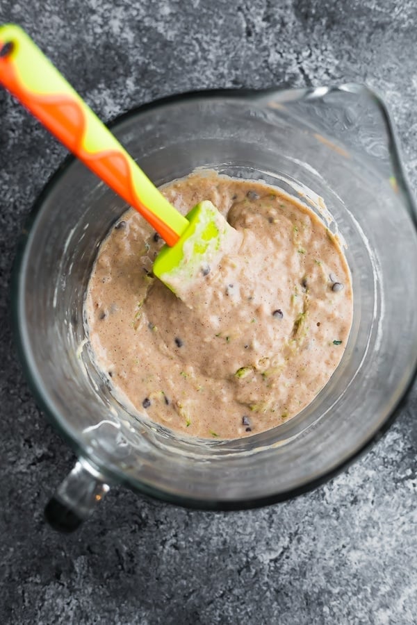 batter mixed up for the zucchini pancakes in glass mixing bowl with handle, from above