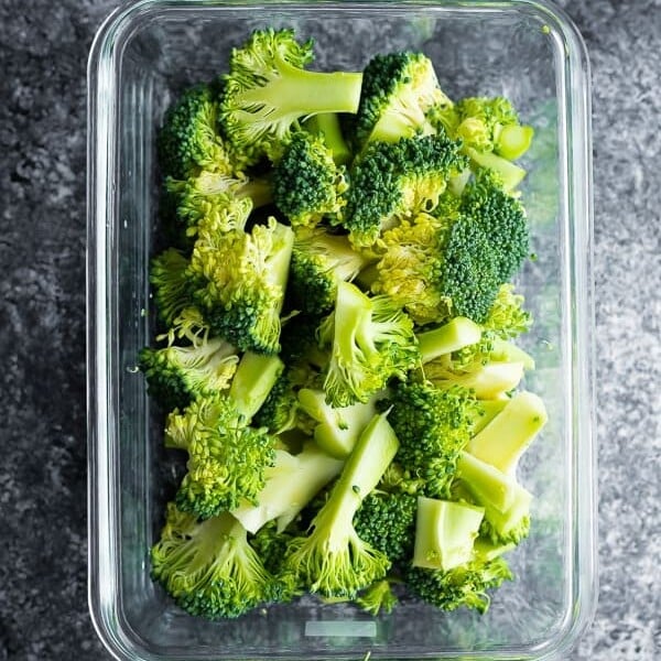 glass meal prep containers filled with cooked broccoli