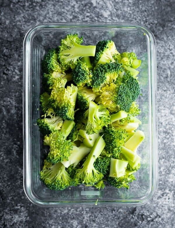 glass meal prep containers filled with cooked broccoli
