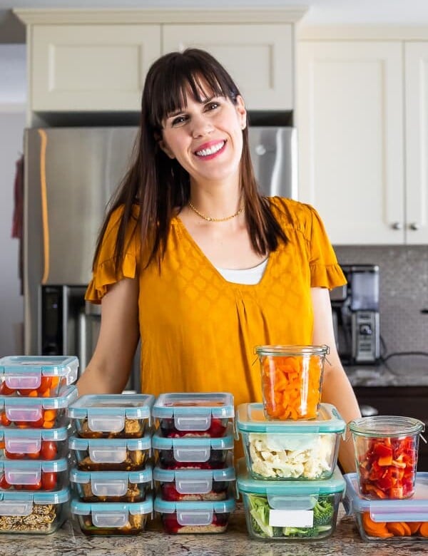 Denise standing at her counter behind stacks of meal prep containers