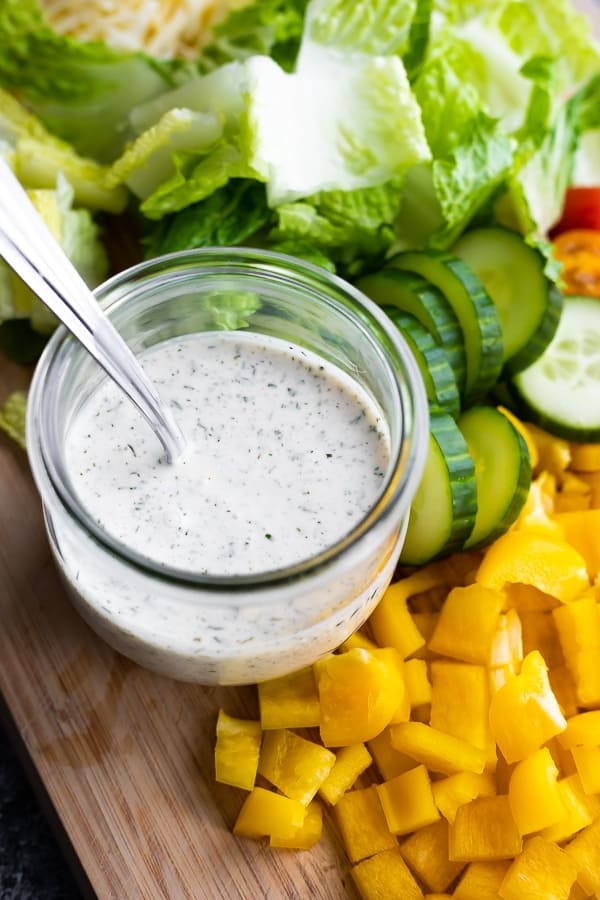 jar of ranch dressing surrounded by vegetables