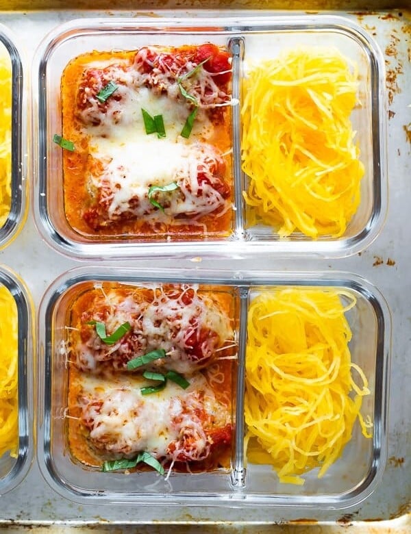 overhead shot of two glass meal prep containers filled with spaghetti squash and meatballs