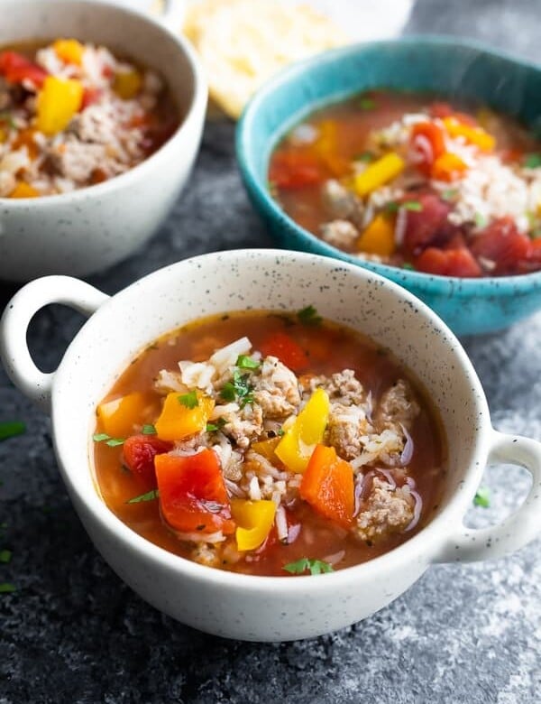 three white and blue bowls of stuffed pepper soup