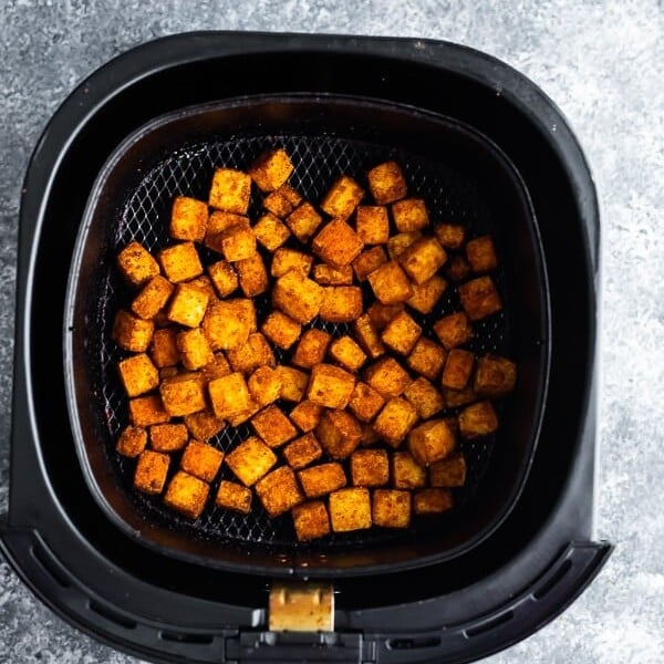 overhead shot of tofu cubes in air fryer