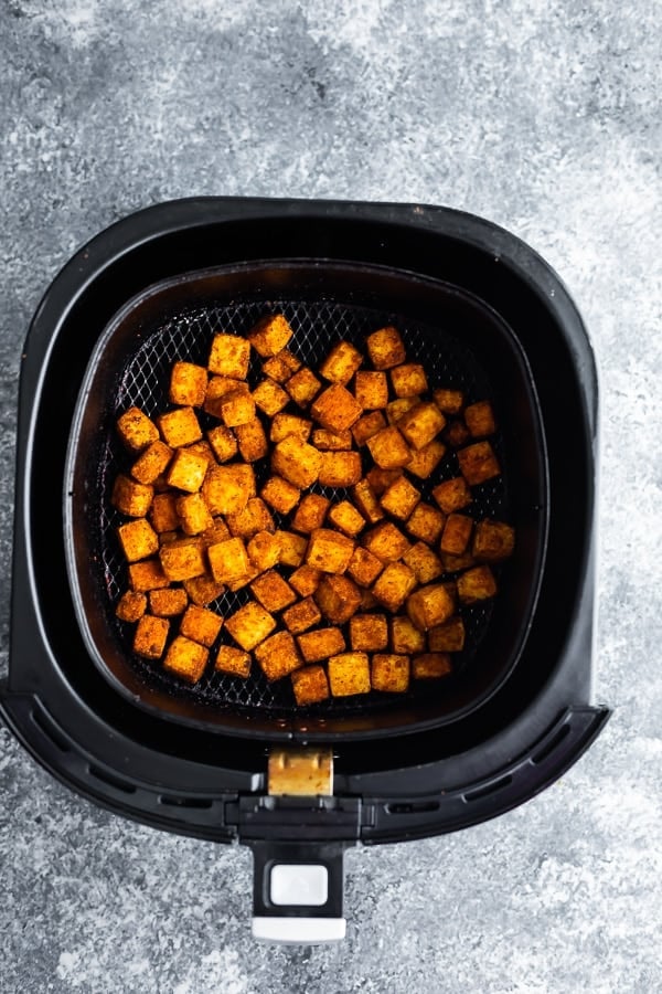 overhead shot of tofu cubes in air fryer