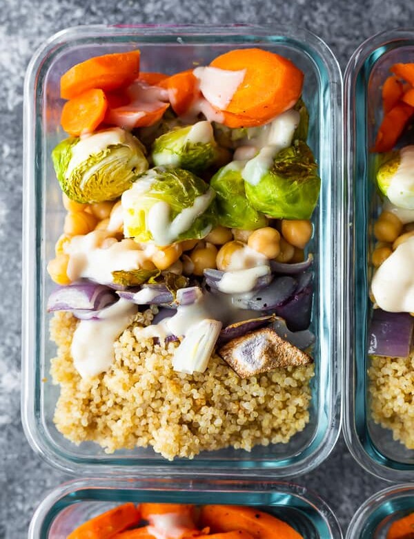 overhead shot of glass meal prep container filled with buddha bowls