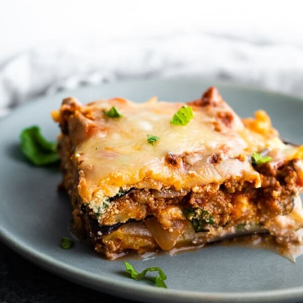 close up of slice of eggplant lasagna on gray plate